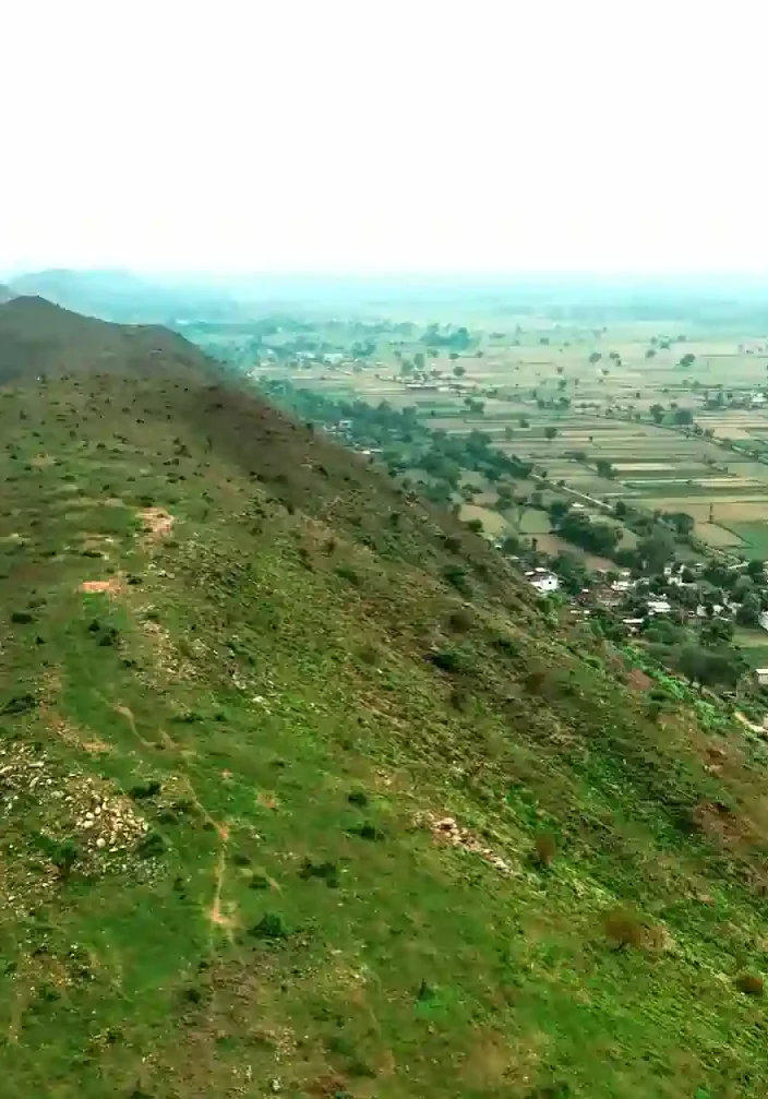 Aerial view of RPS Sargam Phase-1 farmhouses in Naugaon, Alwar with greenery and gated layout